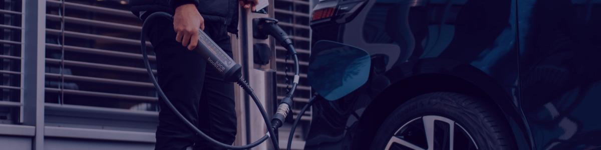 Image of person's hand holding an EV charger