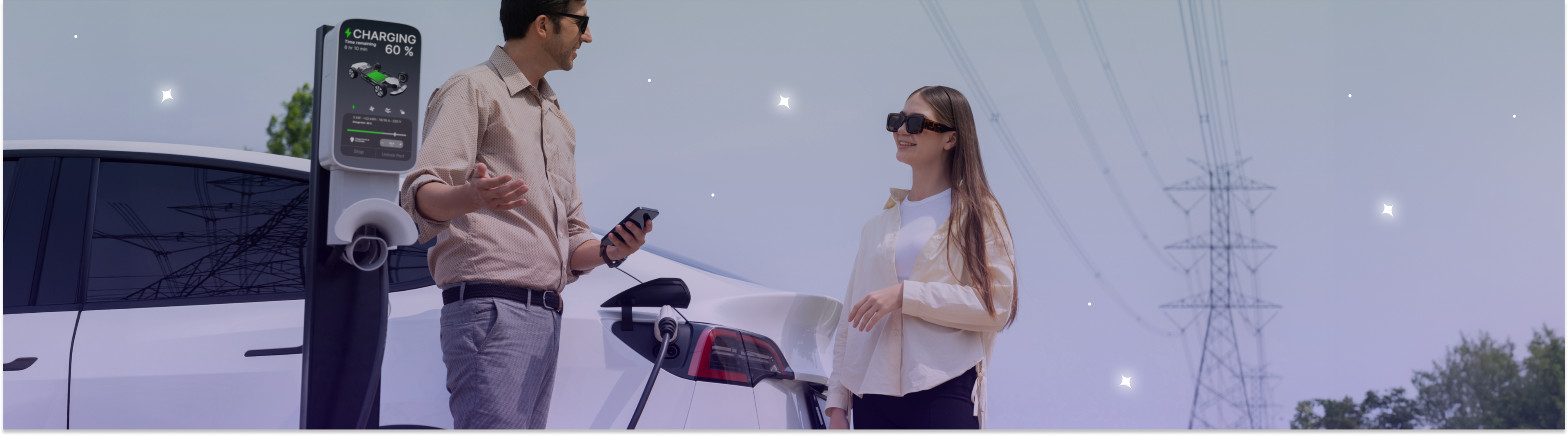 Couple charging their EV with UK power grid lines in the background 