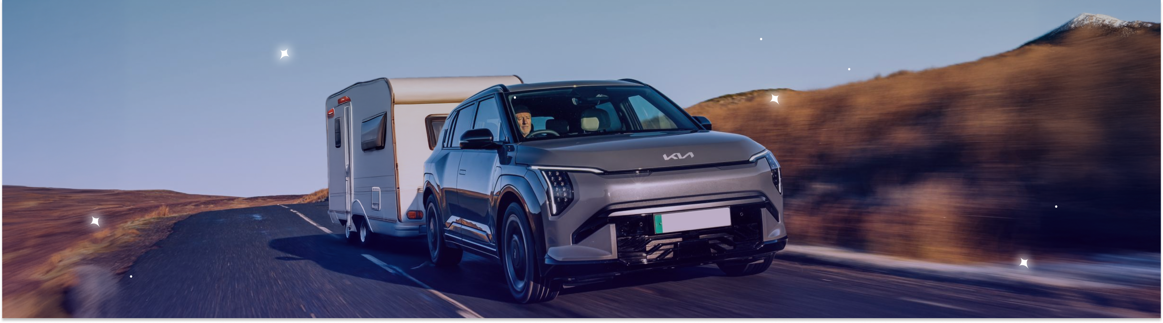 A caravan being towed by an electric car