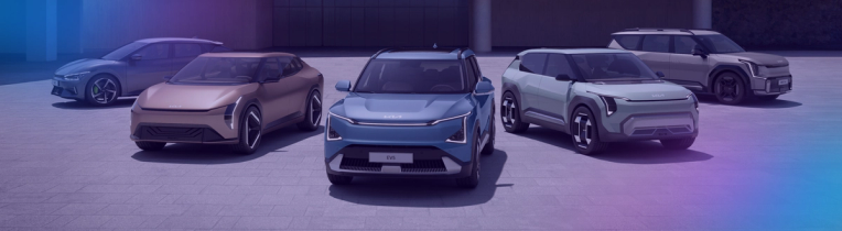Lineup of electric vehicles in front of an office block
