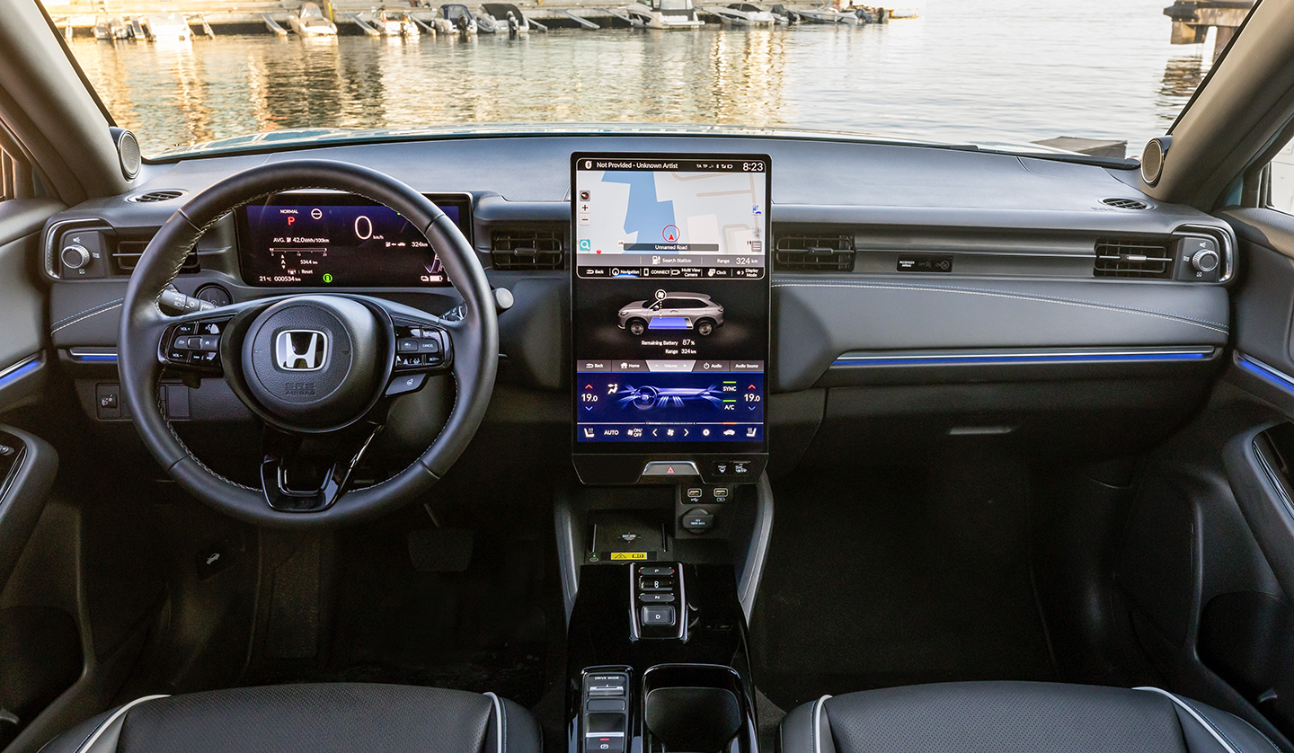 An interior shot of the Honda e:Ny1 showing the steering wheel and dash 
