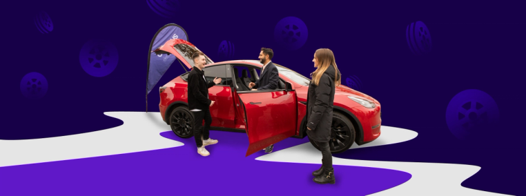 Three people standing next to a red electric vehicle with a purple background