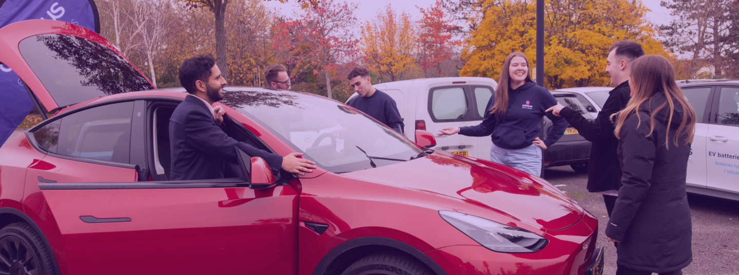 Red Tesla and 3 people 