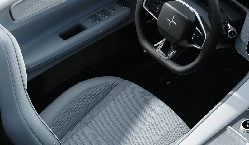 An interior shot of the Polestar 4 displaying the driver seat and steering wheel