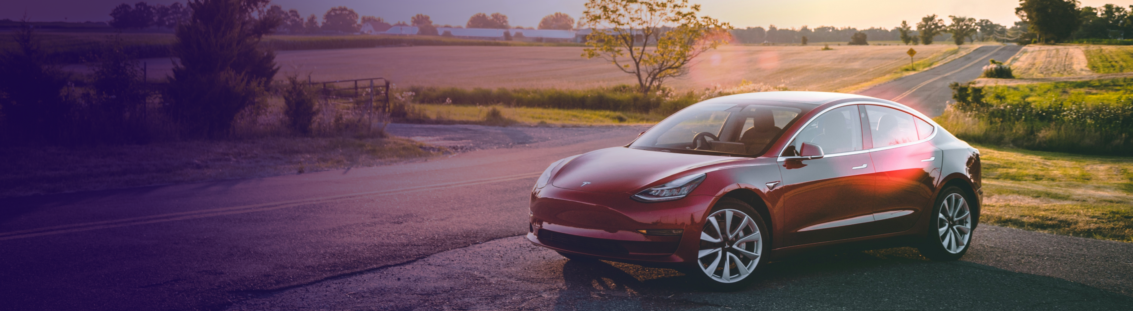 Tesla parked up in the countryside