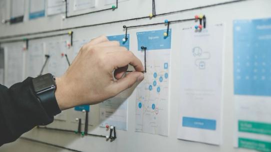 A team testing a new app prototype on a tablet.