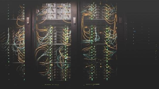 The interior of a modern data centre with rows of equipment.