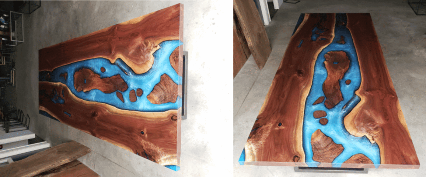 Wood and blue resin river table with natural wood grain patterns, creating a unique artistic design.