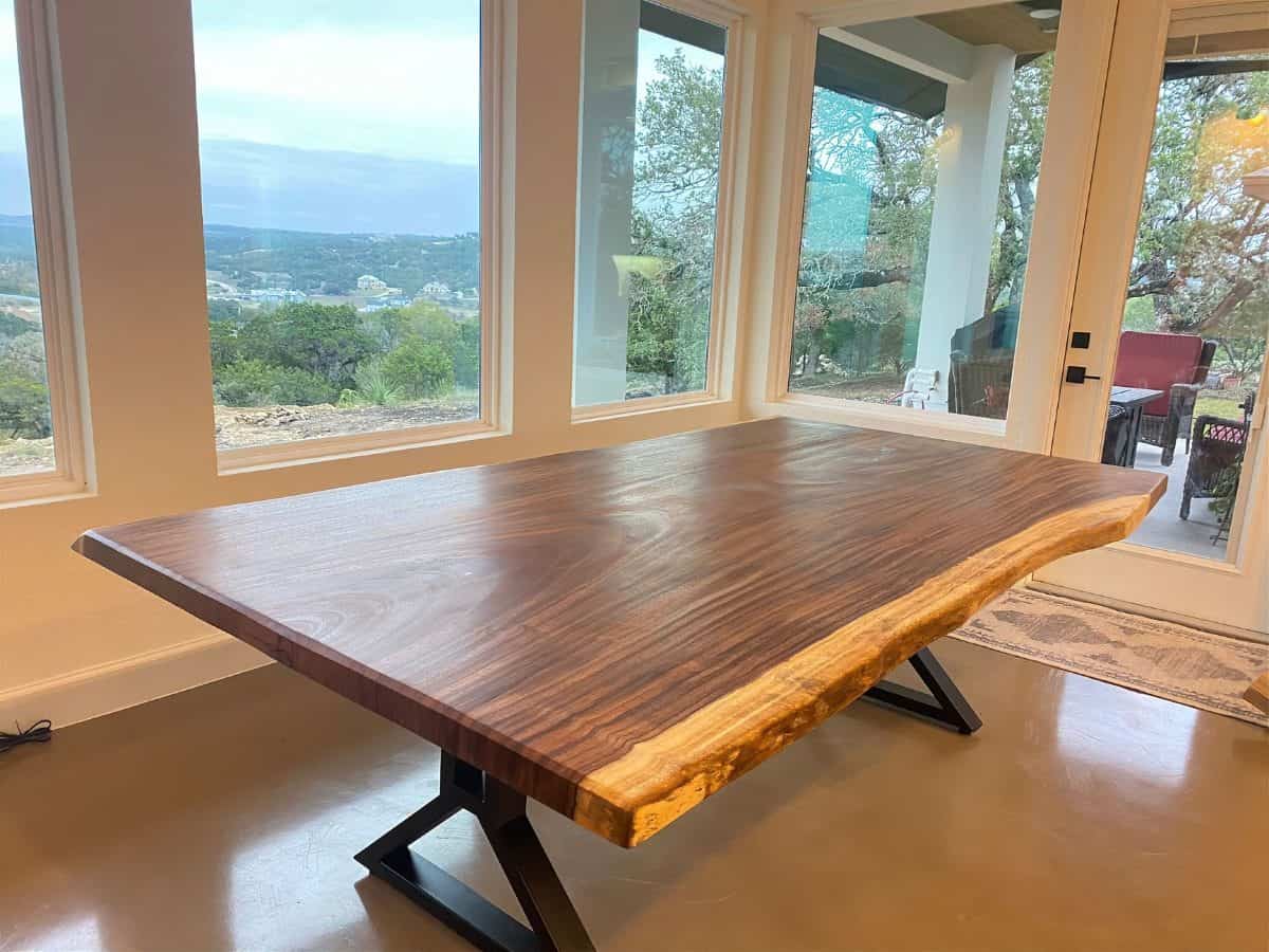 Live edge dining table with metal legs in a modern home