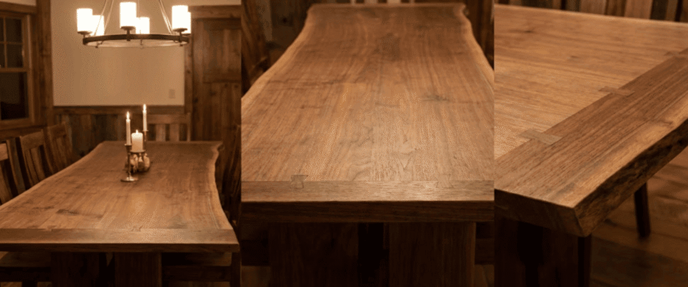 Handcrafted live-edge walnut dining table with butterfly joints, warm candles, rustic wood chairs and soft overhead chandelier glow