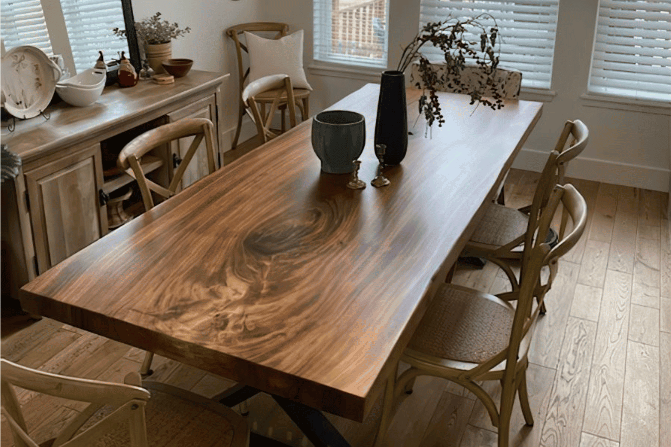 Live-edge walnut dining table with natural grain, mixed chairs, soft lighting — cozy modern farmhouse dining space.