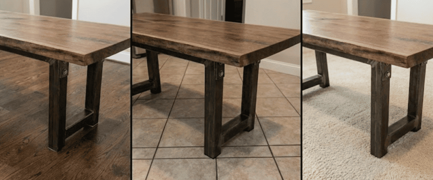 Rustic wooden dining table with thick plank top and sturdy dark metal legs shown on hardwood, tile, and carpeted floors
