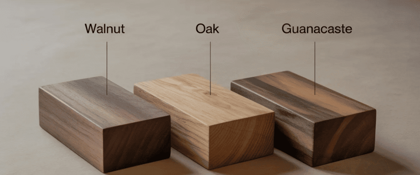 Walnut, oak, and guanacaste rectangular wood samples labeled and shown side-by-side on a neutral surface.