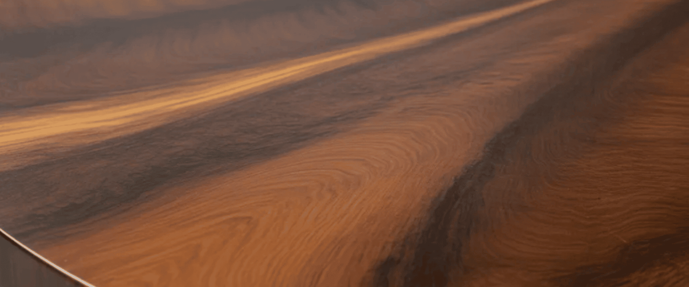 Round-wooden-table-top-with-rich-brown-grain-and-subtle-radial-pattern-smooth-edge