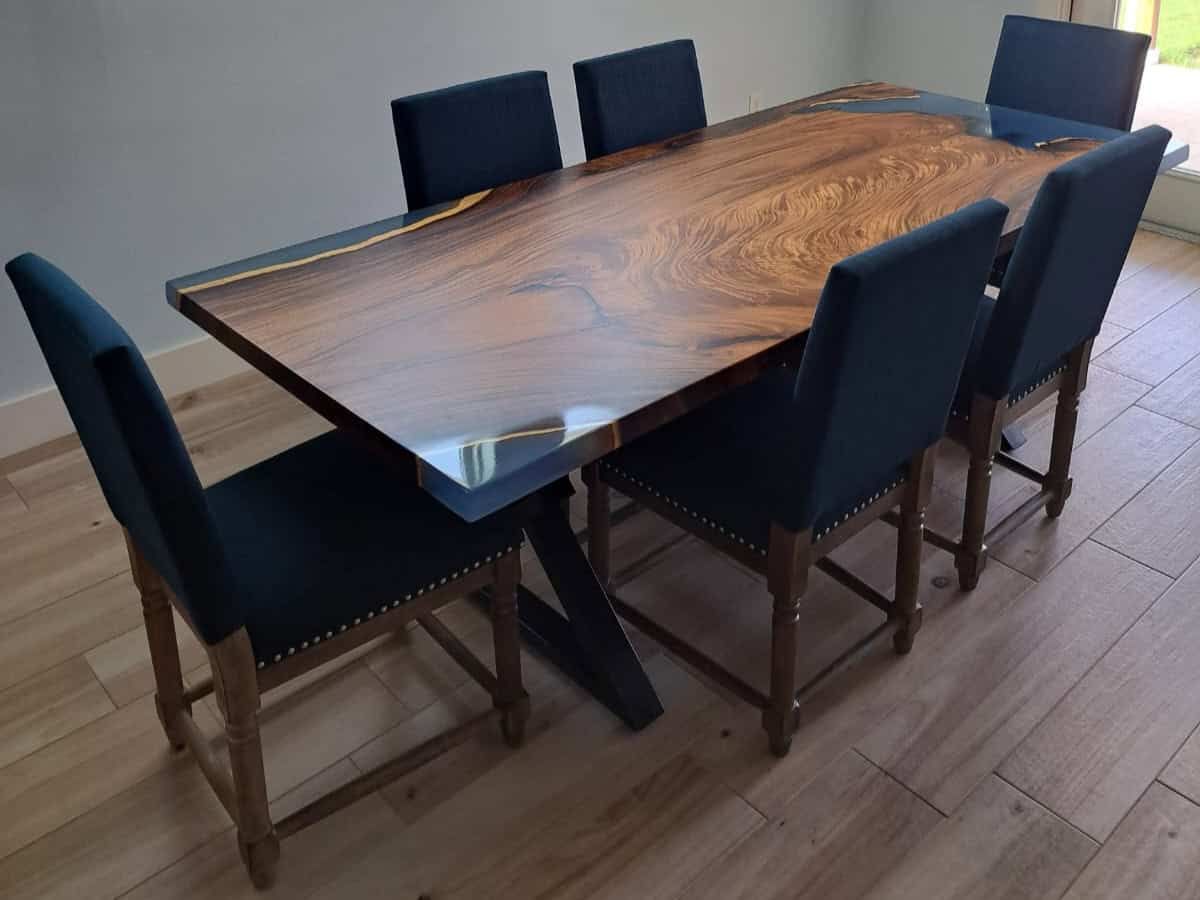 Dining table showcasing how wide it is in a beautifully decorated dining room.