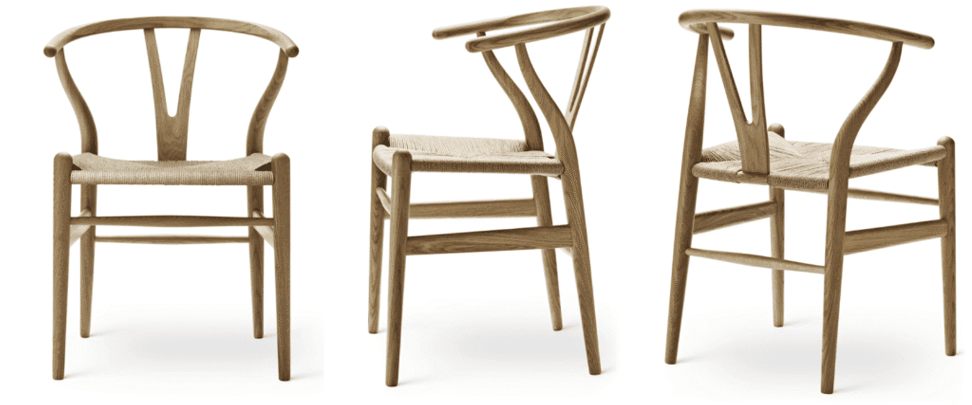 Oak wishbone chair with woven cord seat, curved backrest and tapered legs on black background