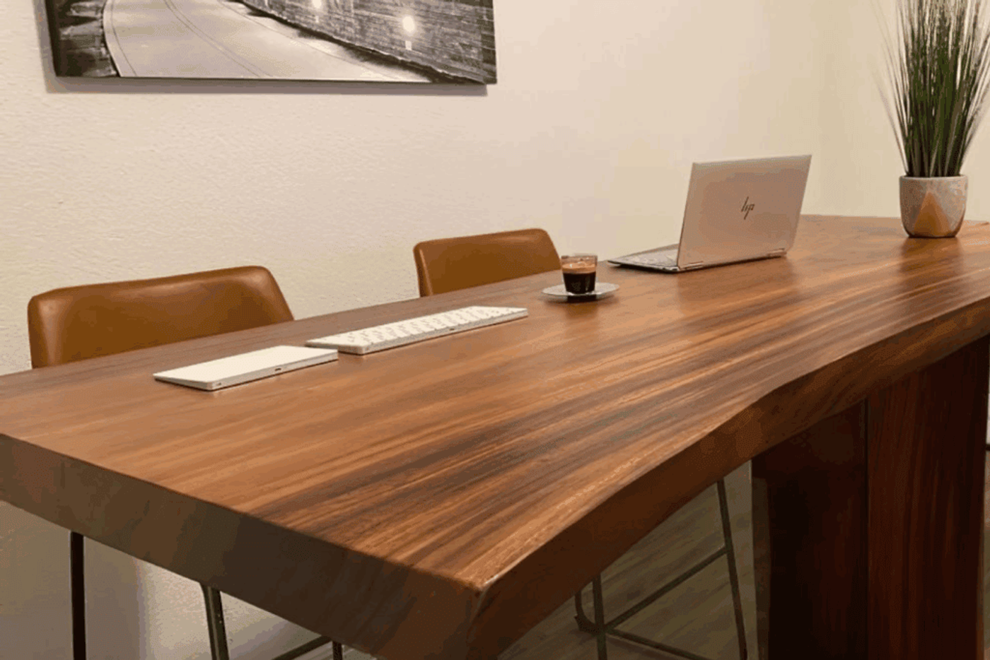 A stylish live-edge wooden desk setup for remote work, featuring a modern workspace with a computer, dual monitors, coffee mug, natural wood grain detail, wood oil bottle, microfiber cloth, and a coaster — all displayed in a clean and aesthetic layout.
