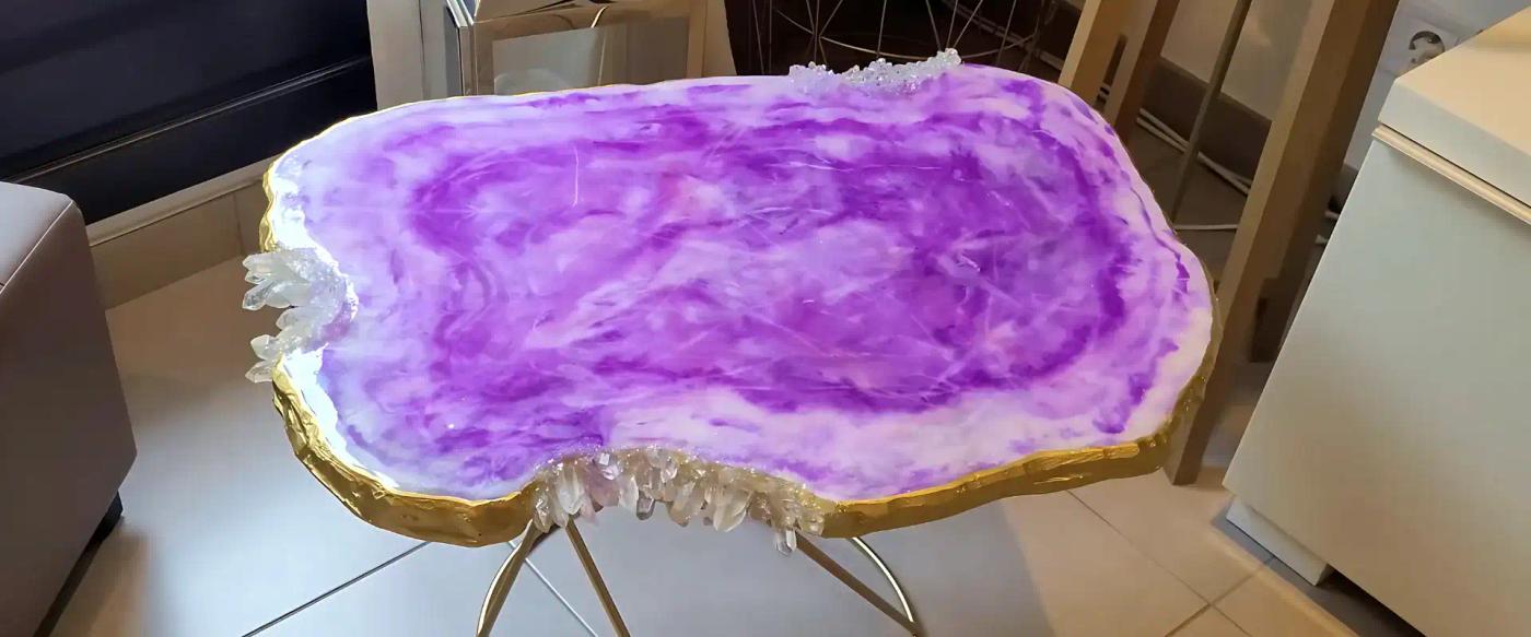 Small-geode-inspired-table-with-a-purple-resin-top-resembling-agate-gold-edges-and-crystal-accents-on-metal-legs