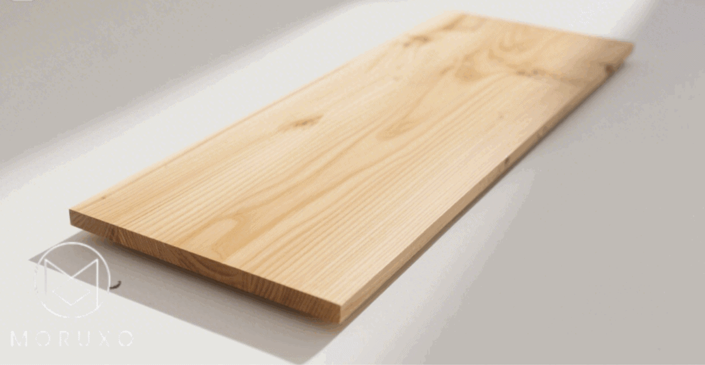 Smooth wooden plank with natural grain pattern placed on a flat surface.