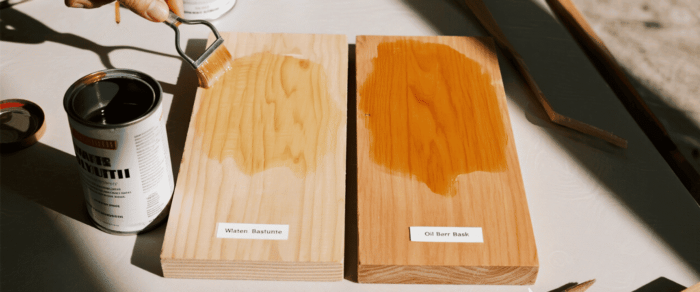 Applying water-based and oil-based finishes on wooden boards to compare color and clarity differences in wood coating