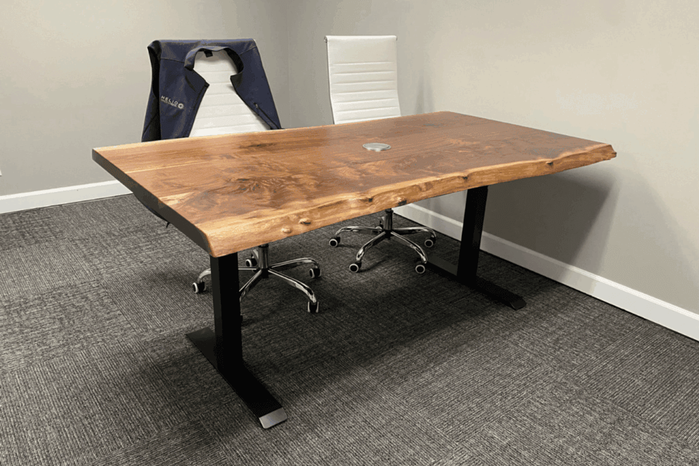 Wooden office desk with natural edges, black metal legs, and two white swivel chairs.