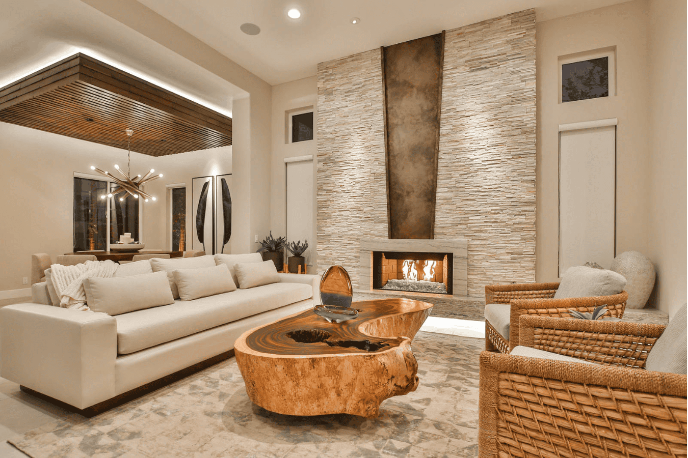 Warm-toned lounge featuring a live-edge wood table with woven chairs and soft beige tones, ideal for rustic organic interiors.