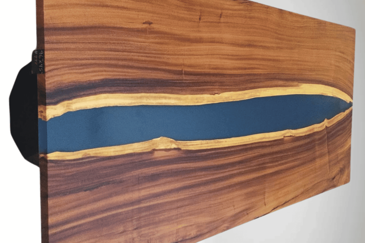 Live edge wood table with blue epoxy resin river design, showcasing natural wood grain and smooth finish. Perfect for modern decor.