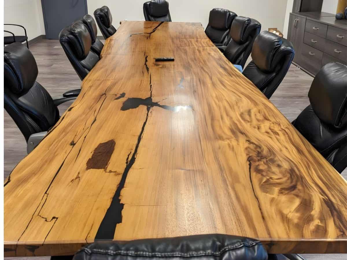 A natural wood live edge conference table, showcasing the unique contours of the wood, perfect for modern office settings.