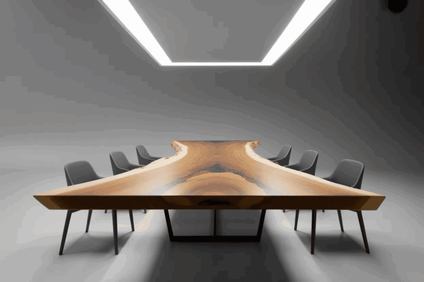 Modern conference table with natural wood grain and unique shape, surrounded by black chairs in minimalist room with bright ceiling light.