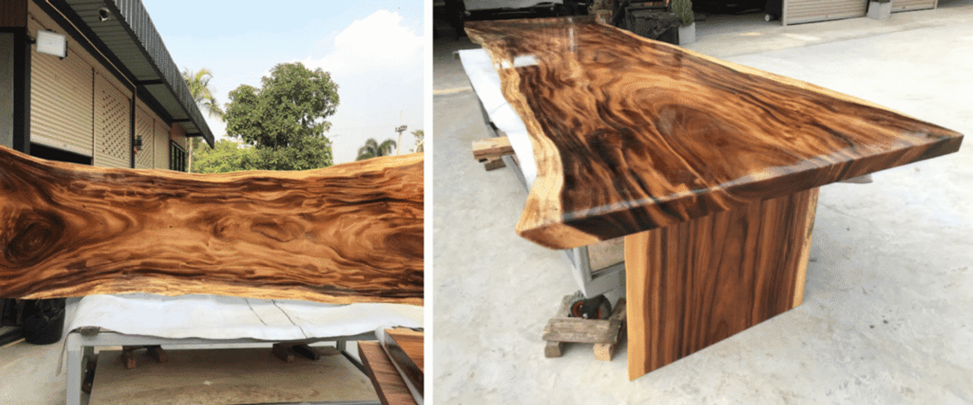 Handcrafted live-edge slab of richly grained wood with swirling caramel and dark brown patterns held horizontally outdoors