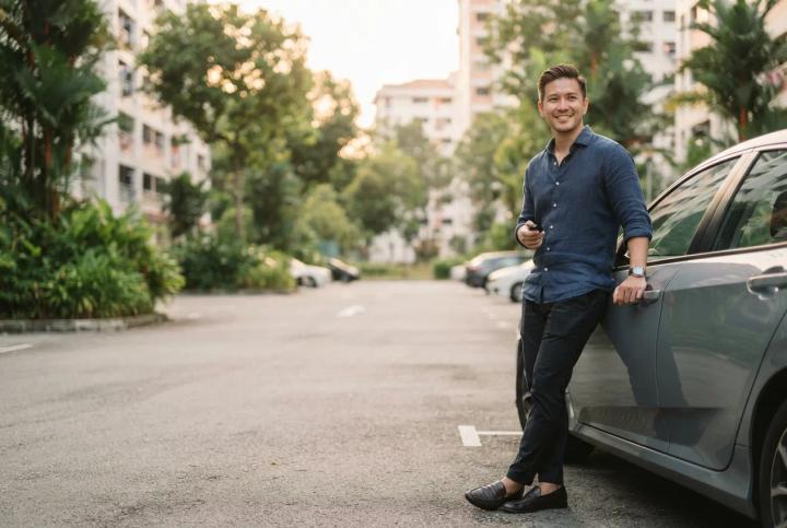 New PR beside his car in a Singapore HDB carpark after converting a foreign driving licence