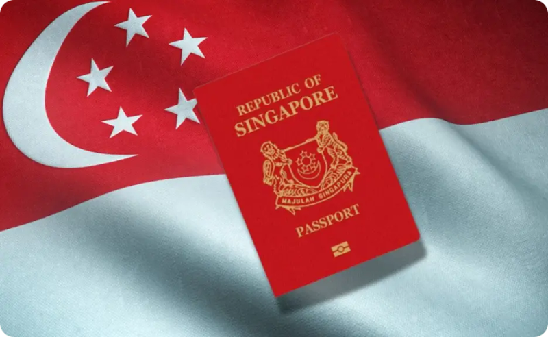 Singapore passport resting on the Singapore national flag.
