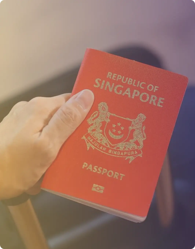 Hand holding a Singapore passport close-up.