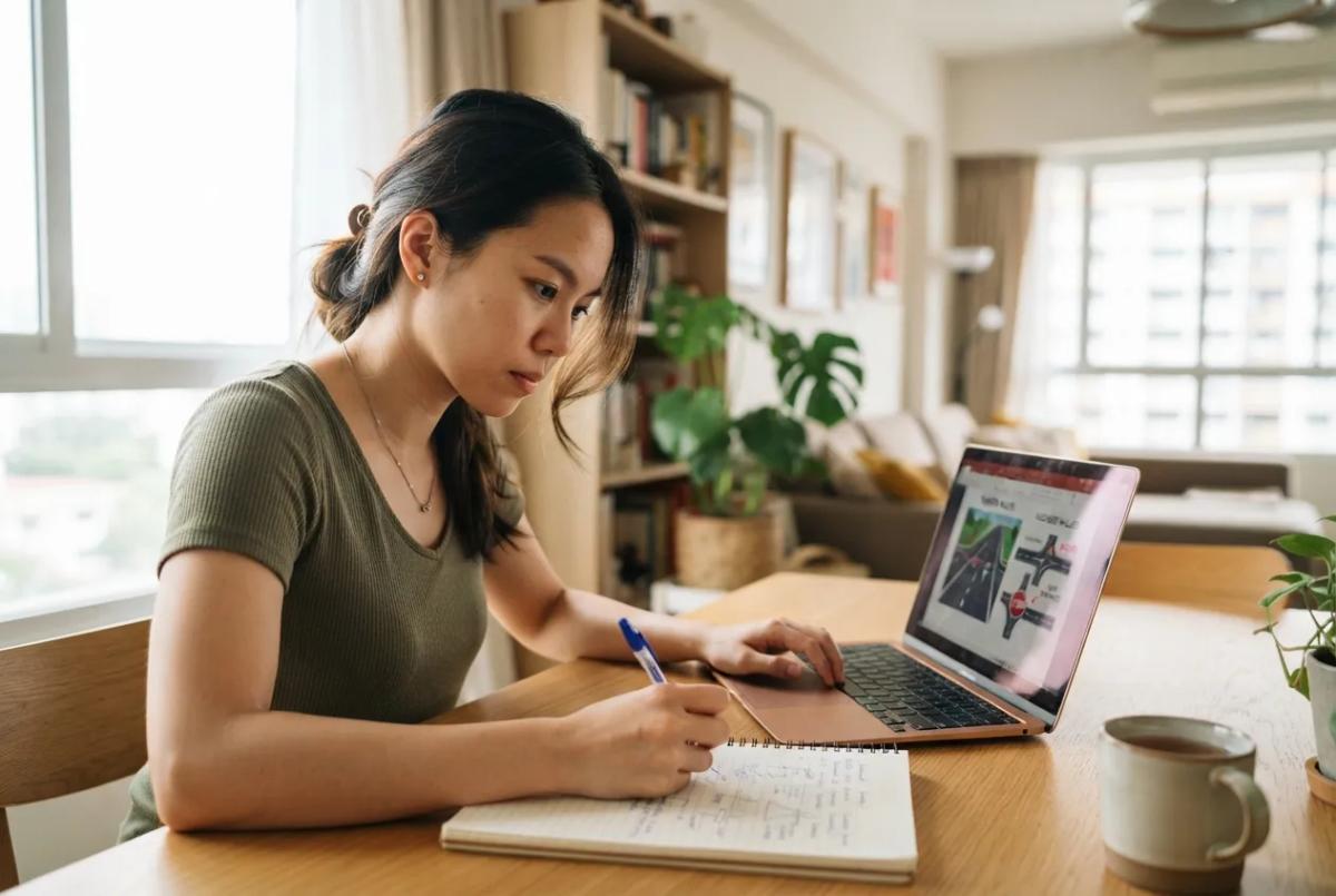 Foreigner studying Basic Theory Test material to convert a foreign driving licence in Singapore