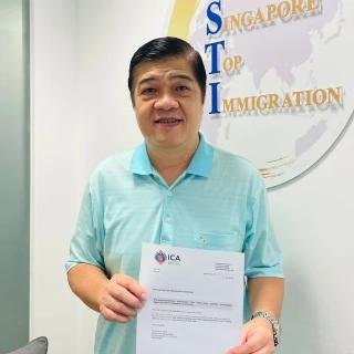Chee, a Singapore Top Immigration client, holding their ICA approval letter