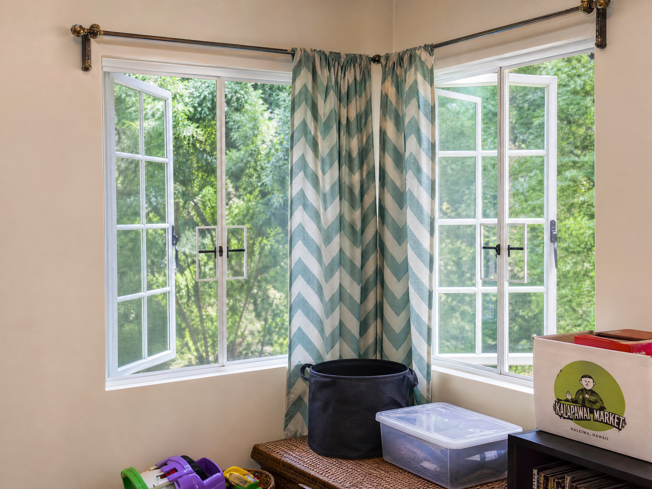 Corner windows with custom screens and curtains in a residential room