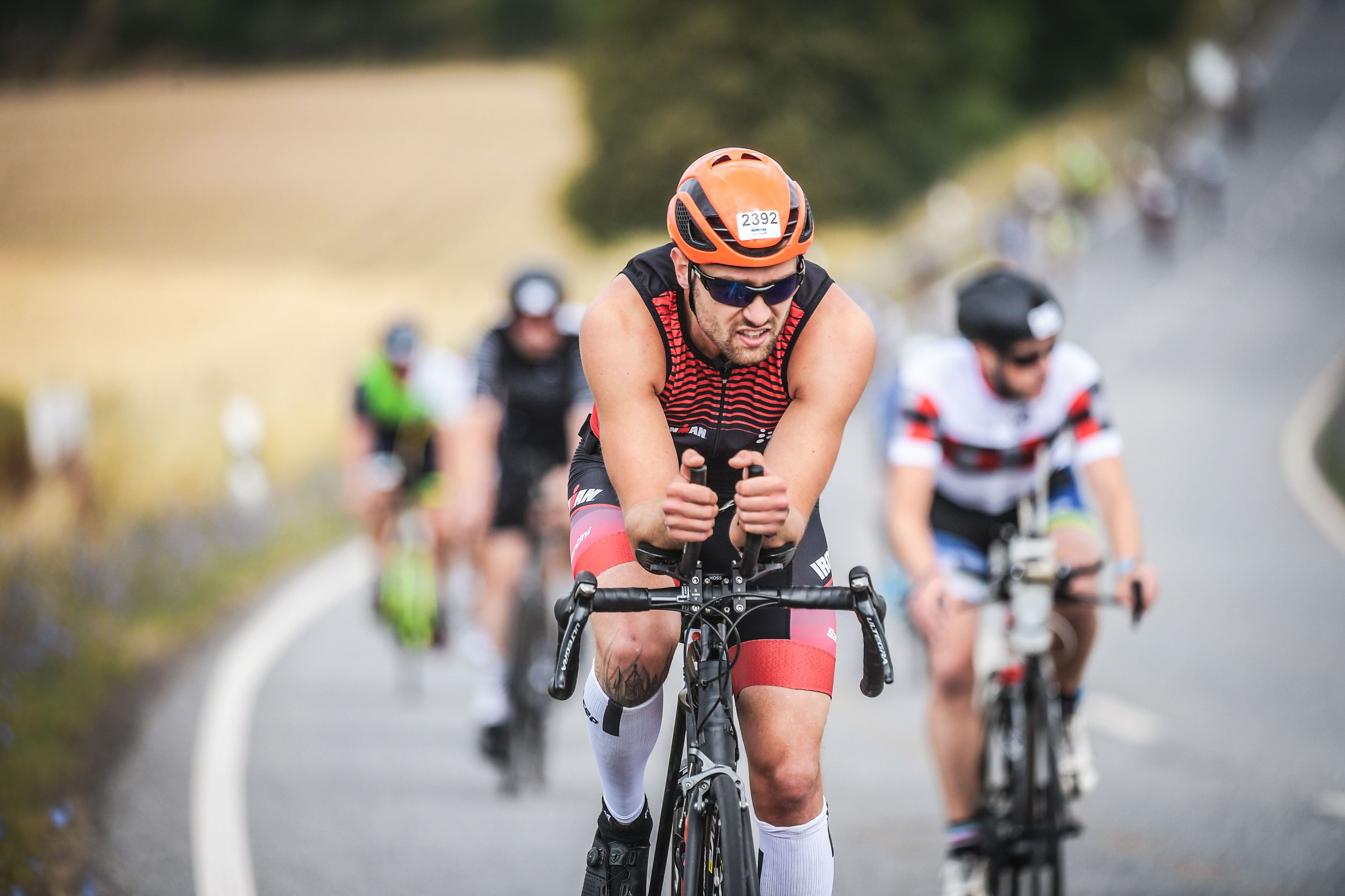 David Bossek cycling in an Ironman triathlon, before the expedition.