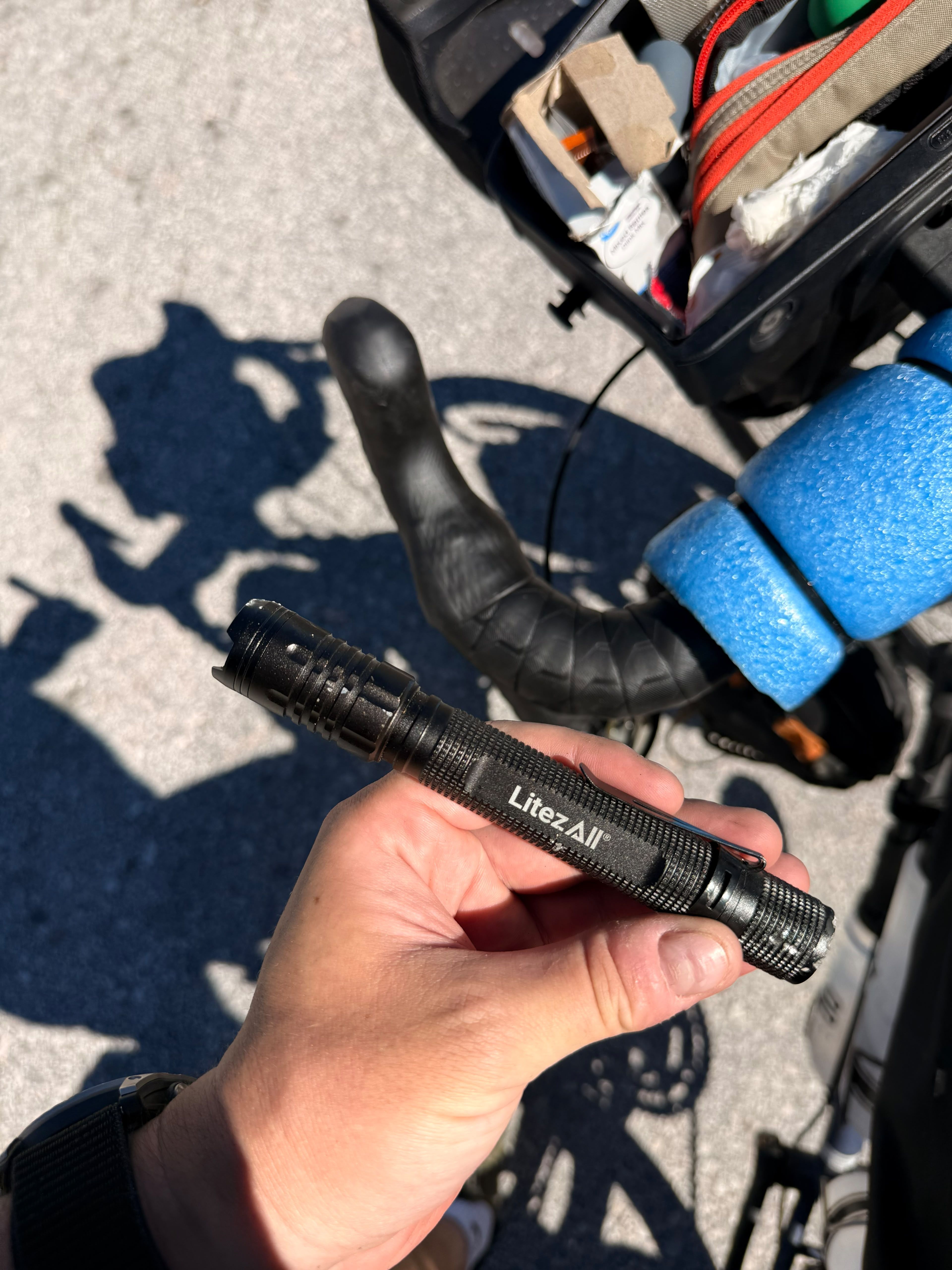 A black torch held over the handlebars