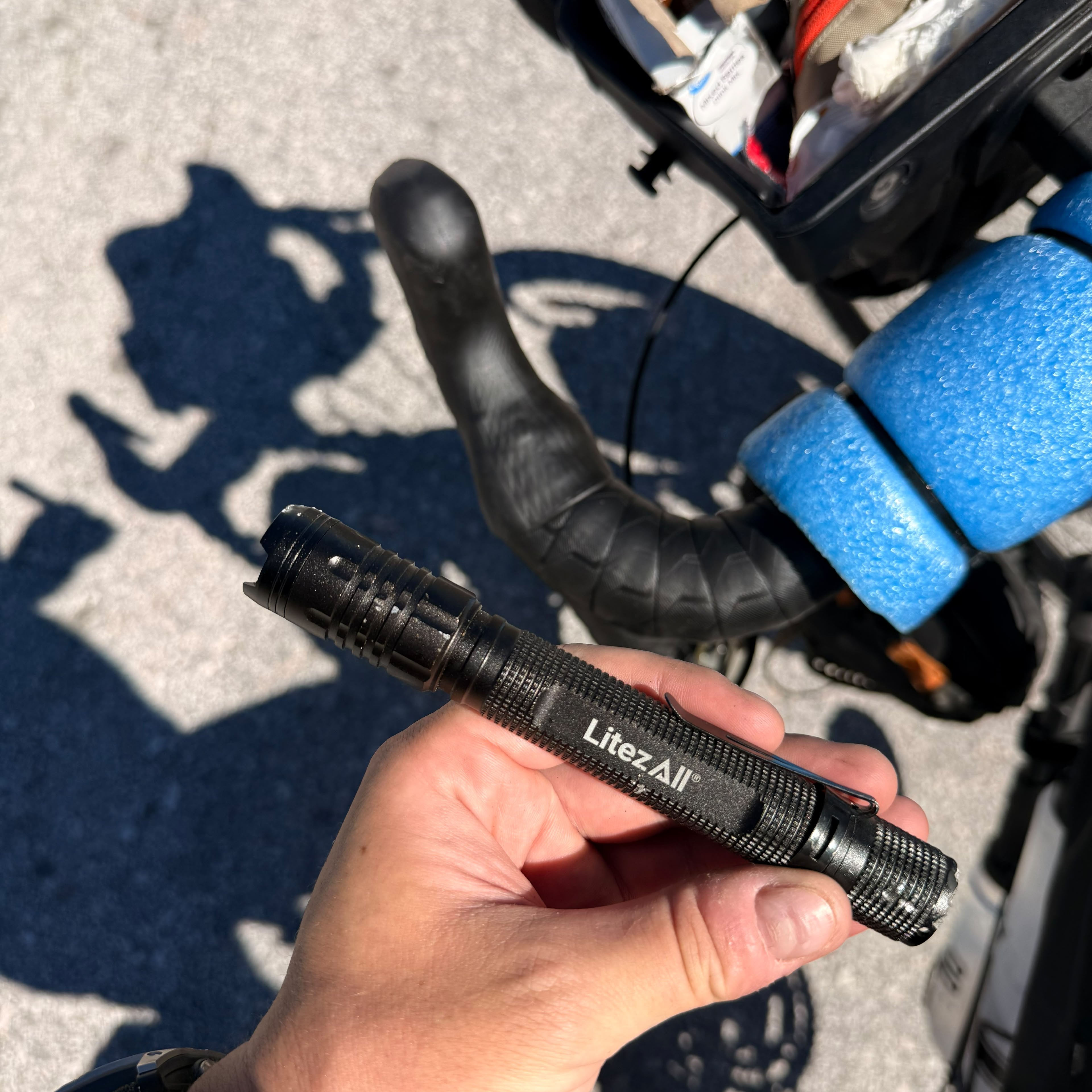 A black torch held over the handlebars