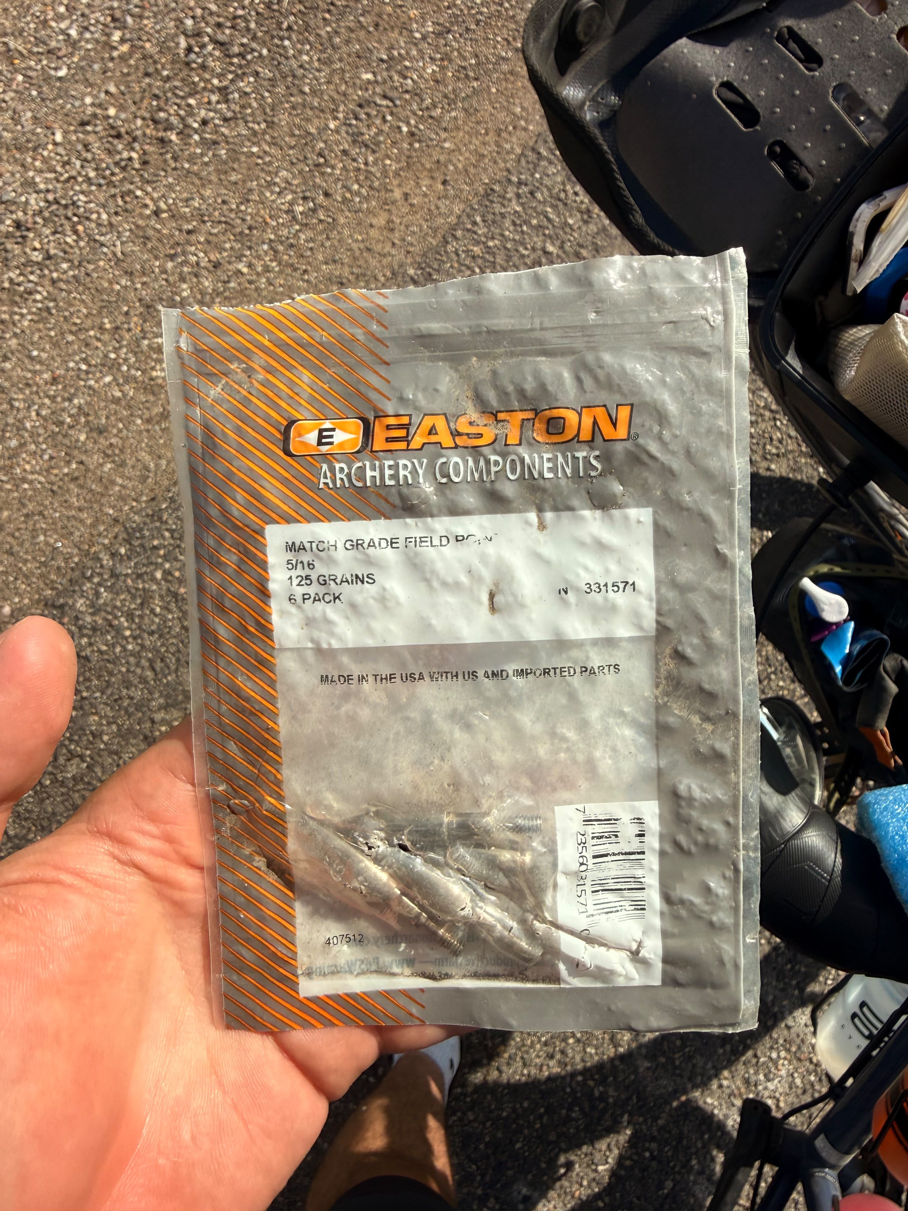 A pack of archery components held in a hand