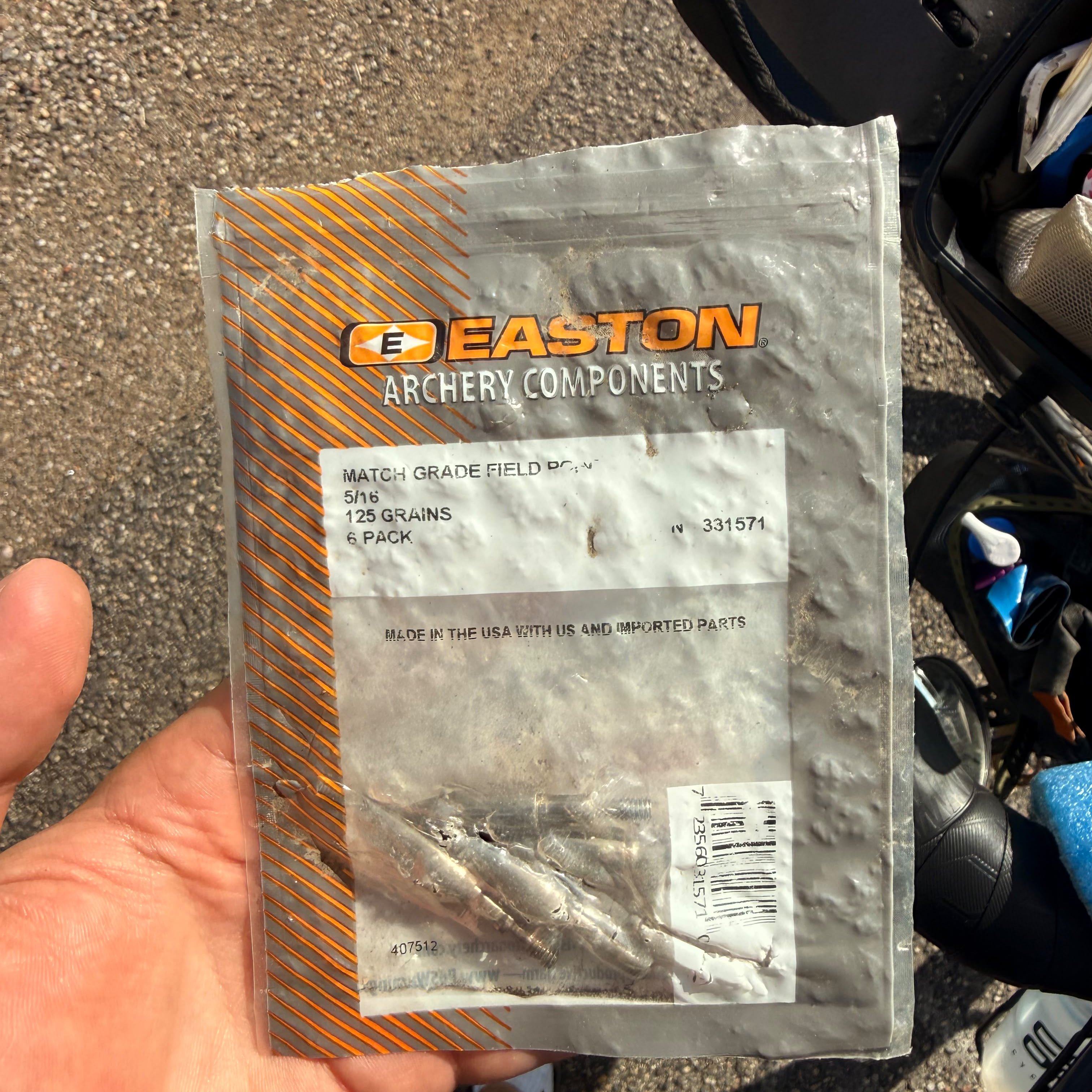 A pack of archery components held in a hand