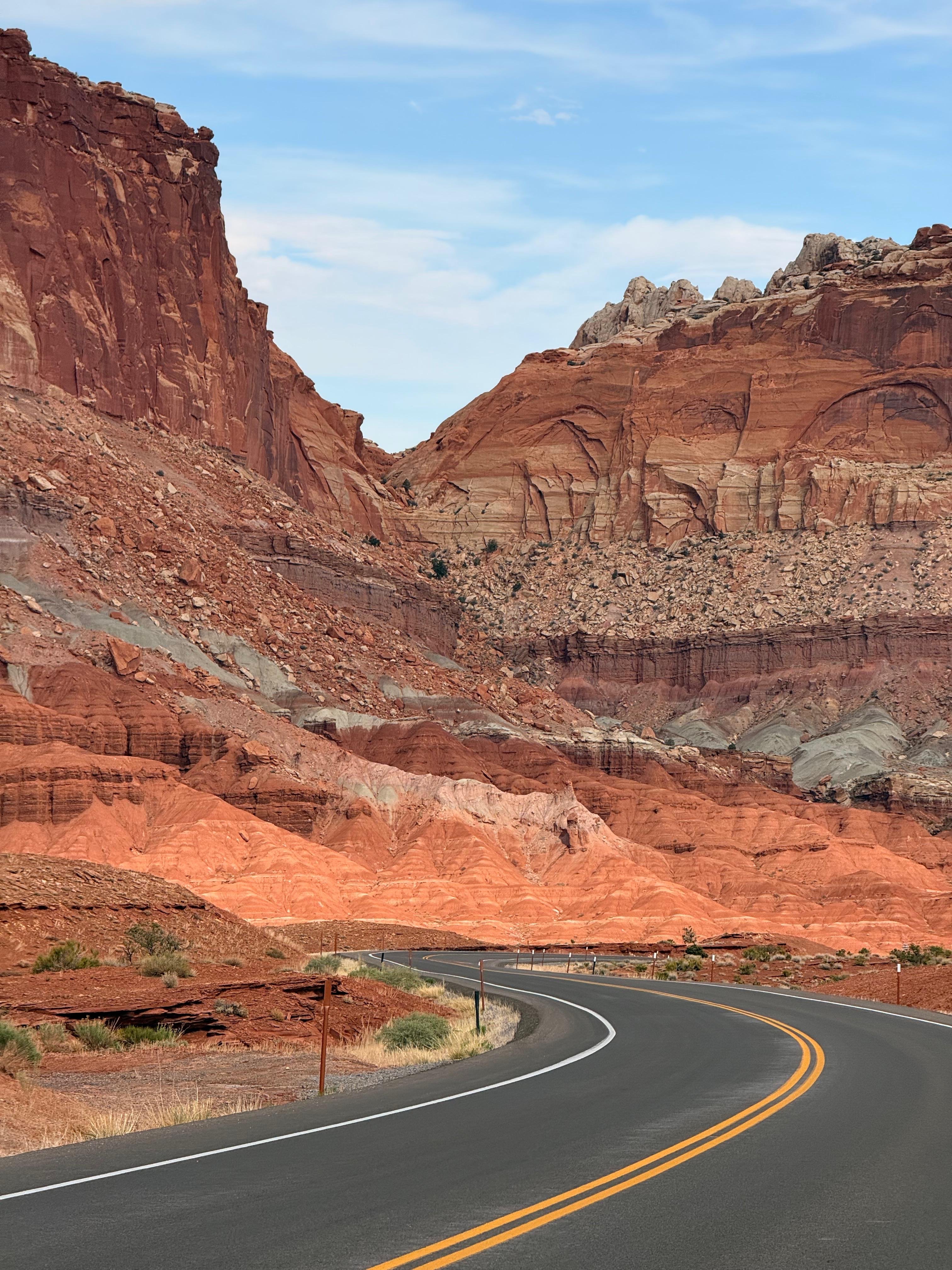 A road curving through red rock cliffs