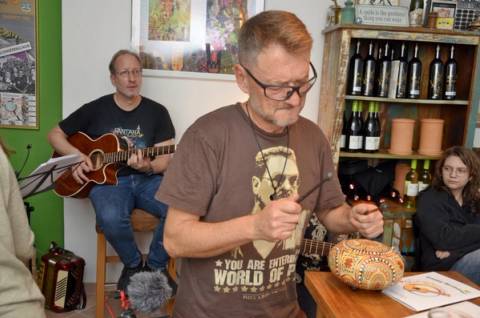 Percussionist mit Rassel bei einem Auftritt in einer Weinstube