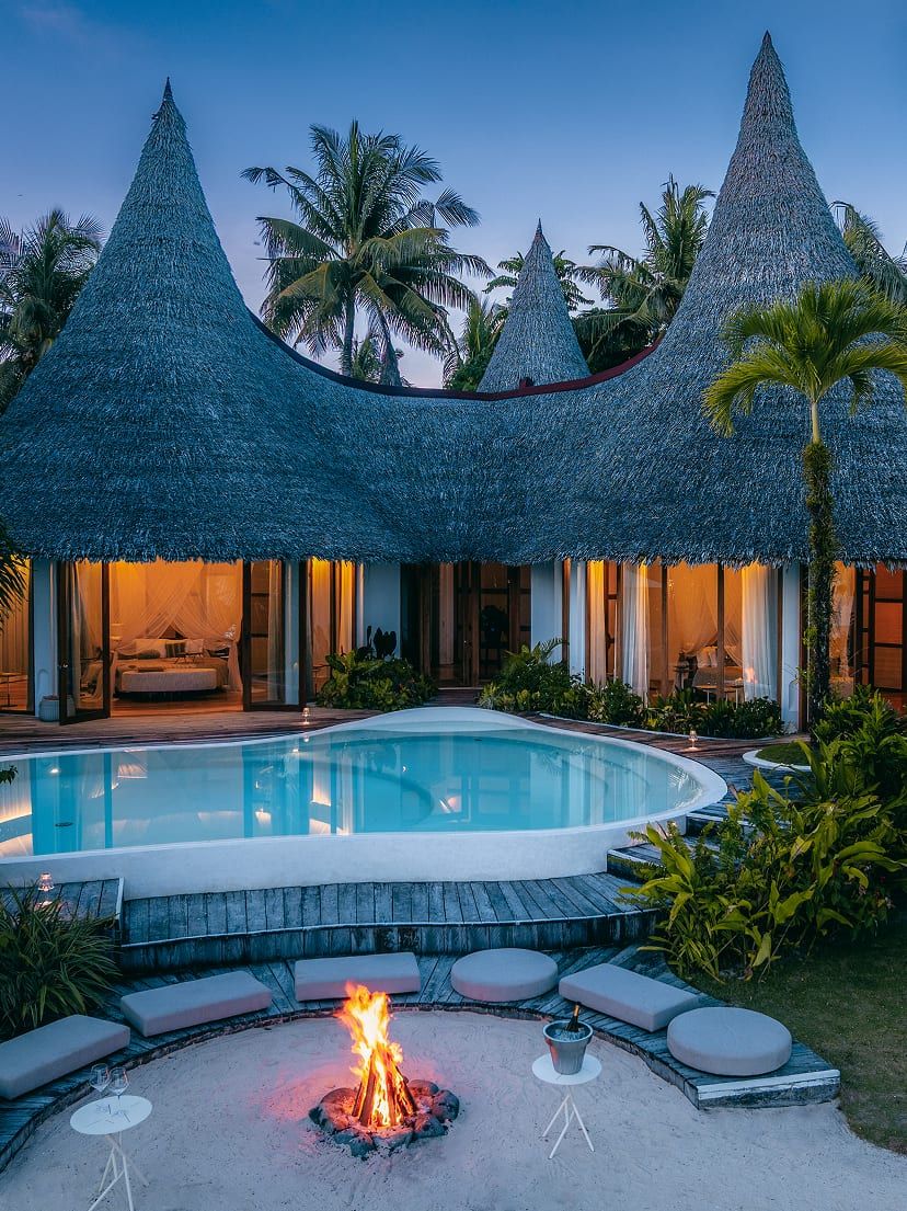 A villa at Nay Palad Hideaway with its pool, as evening falls