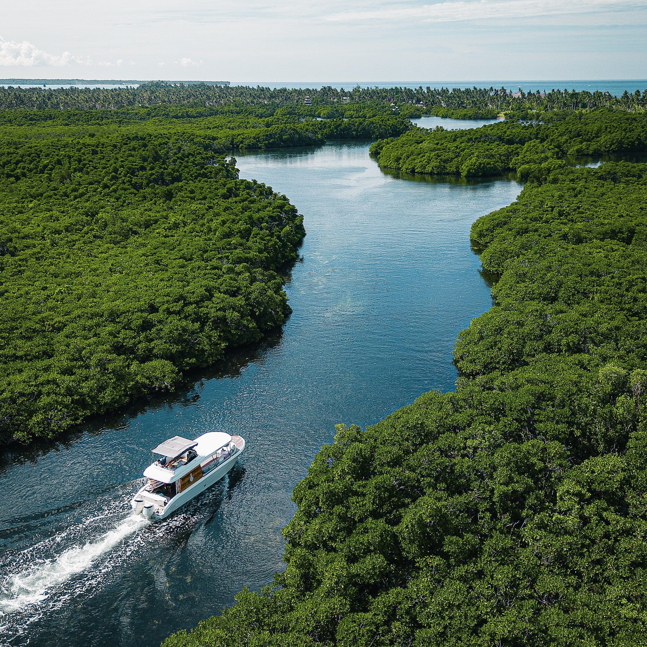 A boat moving through the mangroves of Siargao, seen from the air