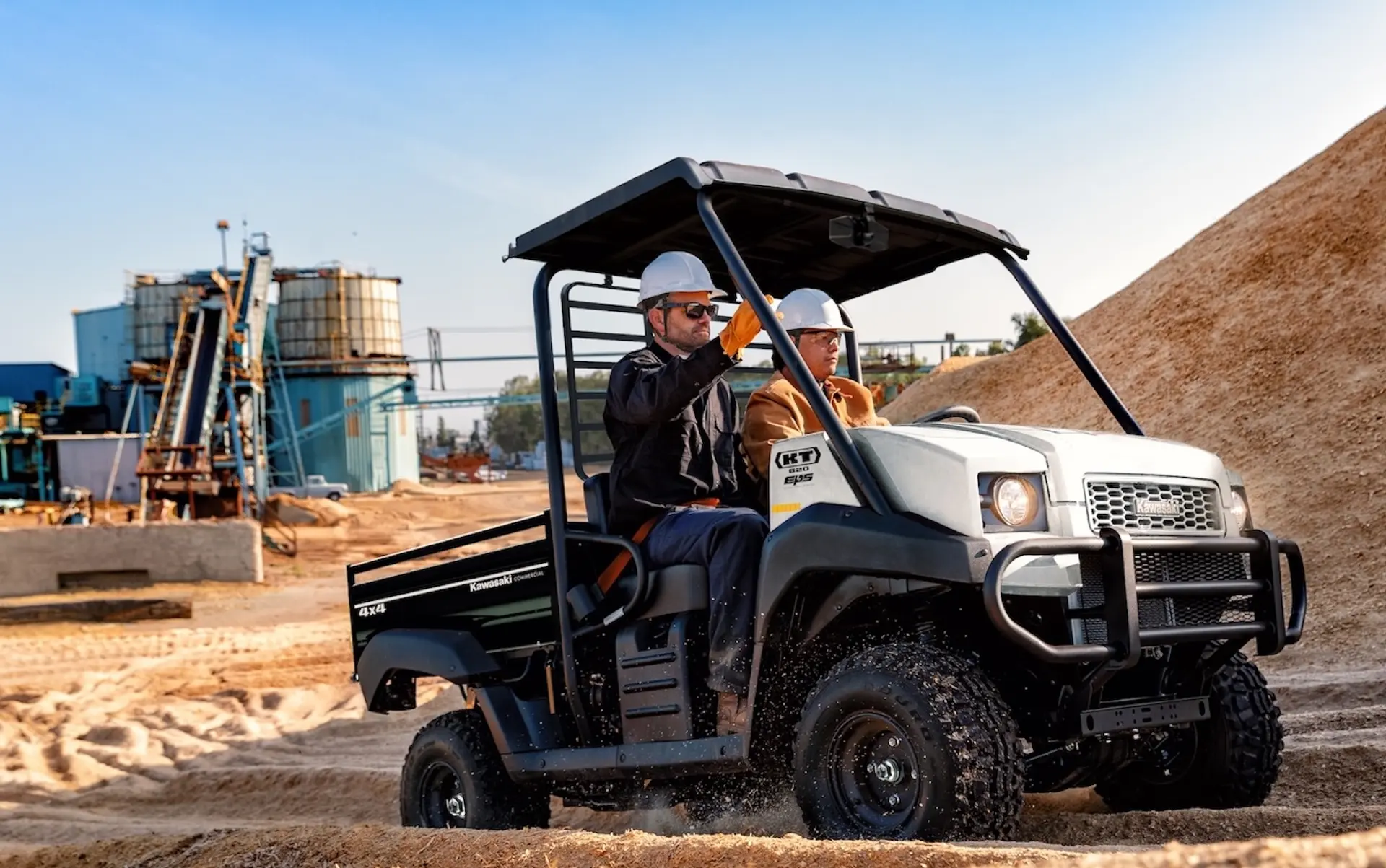 Kawasaki KT UTV driving on worksite.