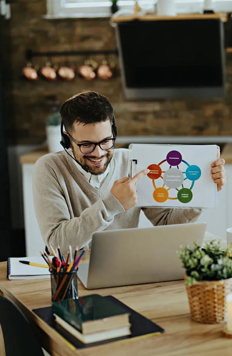Man with glasses and headset working on laptop