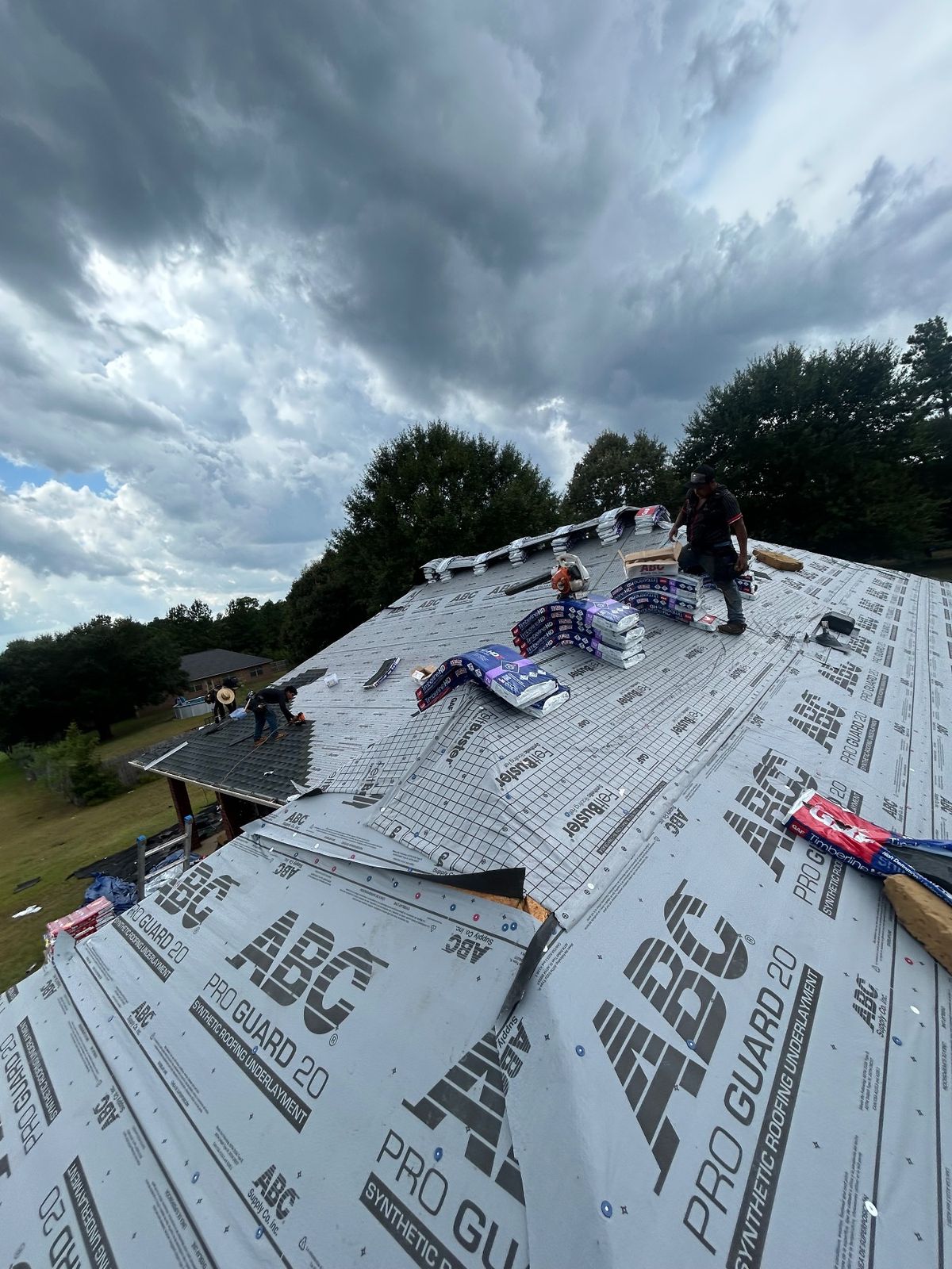 In Progress photo of a GAF Timberline HDZ shingle roof in Charcoal being installed by Southeast Roofing in Perkinston, MS.