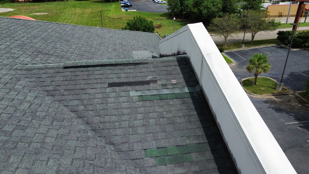 Before photo of a storm-damaged roof before work by Southeast Roofing in Picayune, MS.
