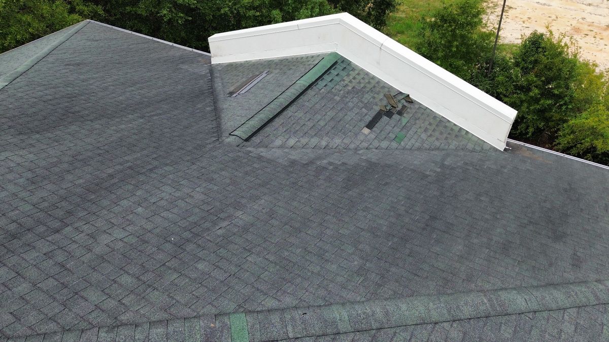 Before photo of a storm-damaged roof before work by Southeast Roofing in Picayune, MS.